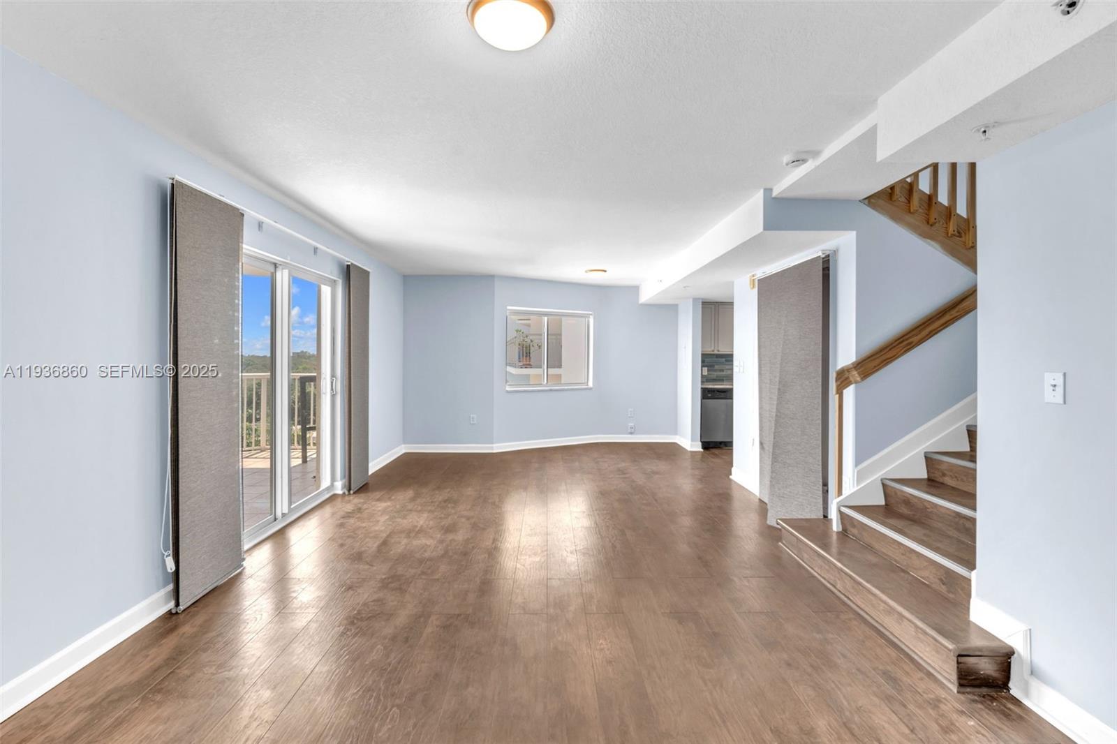280 Southwest 20th Road, Unit 904 Miami, FL 33129 - Photo 19 of 36 a view of an empty room with wooden floor and a window