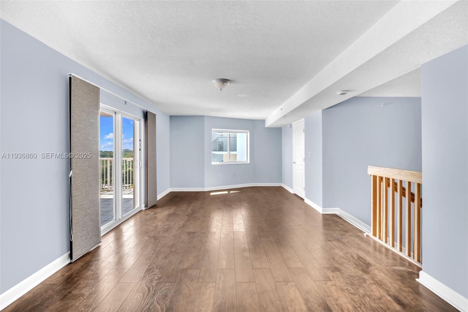 280 Southwest 20th Road, Unit 904 Miami, FL 33129 - Photo 2 of 36 a view of an empty room with wooden floor and a window