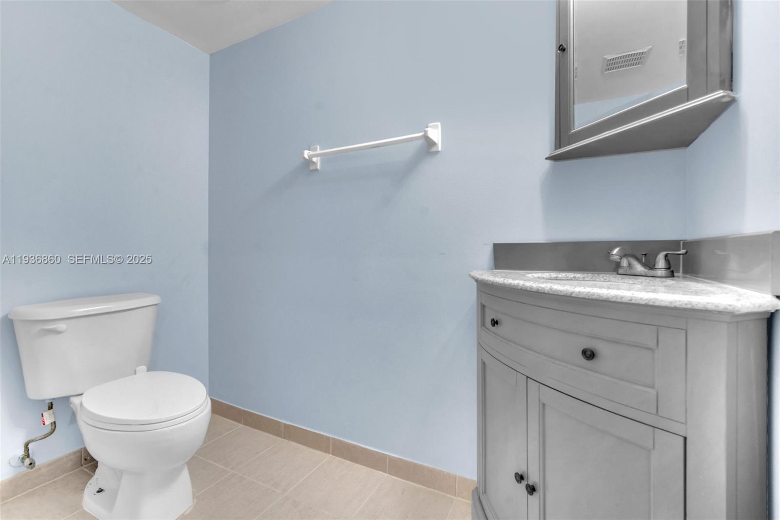 280 Southwest 20th Road, Unit 904 Miami, FL 33129 - Photo 23 of 36 a bathroom with a sink a toilet and a mirror