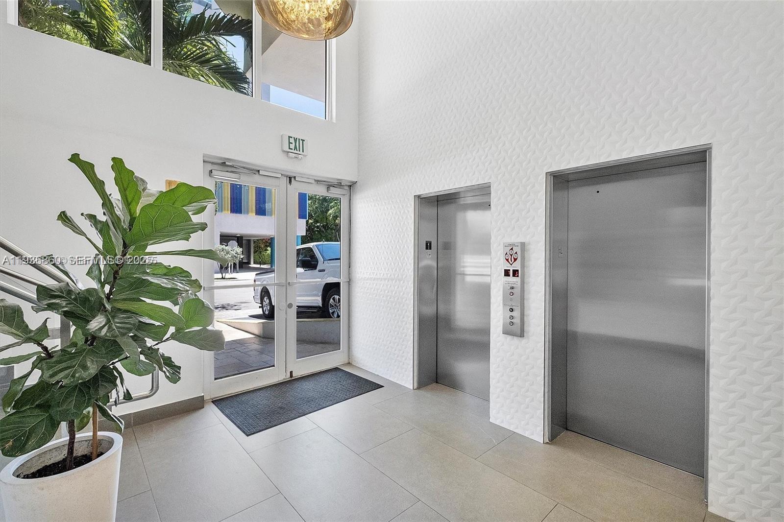 280 Southwest 20th Road, Unit 904 Miami, FL 33129 - Photo 35 of 36 a room with furniture a potted plant and kitchen view