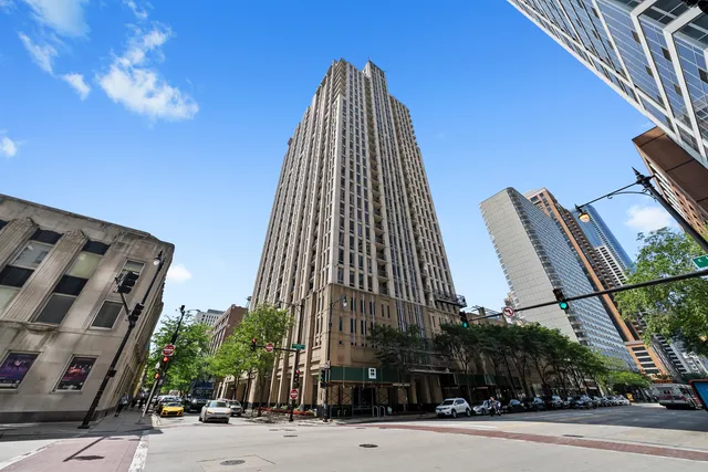 a view of a tall building next to a road