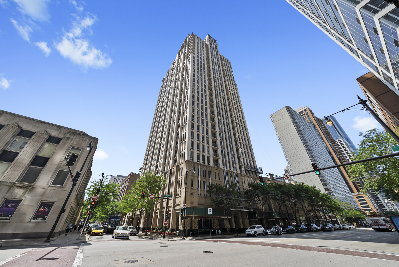 a view of a tall building next to a road