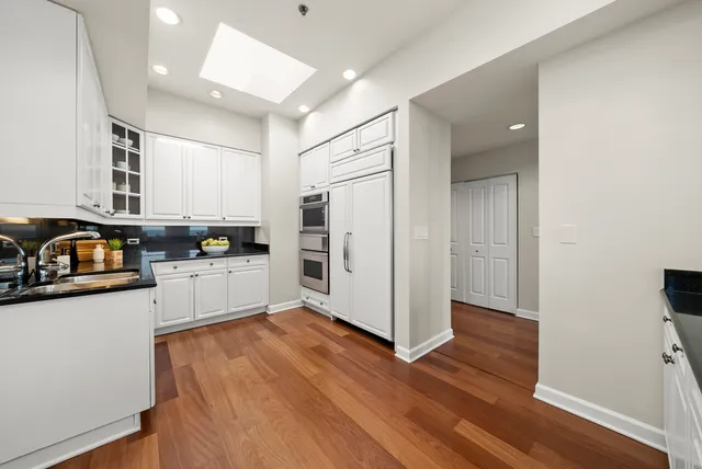 a kitchen with stainless steel appliances a refrigerator sink and cabinets