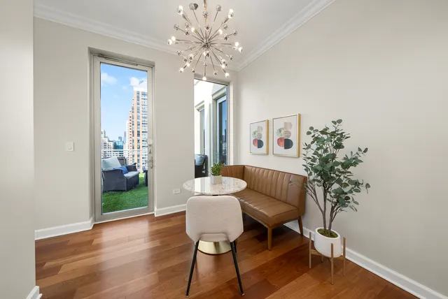 a living room with furniture and a chandelier