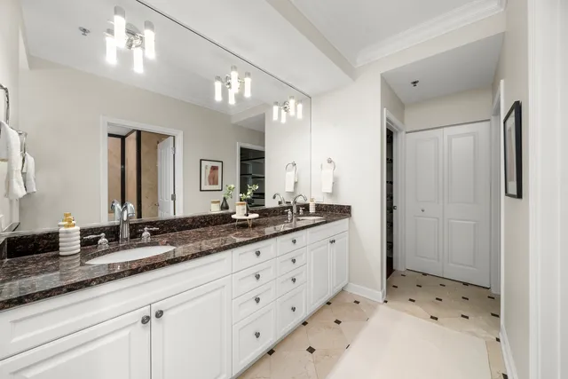 a bathroom with a sink double vanity granite and a mirror