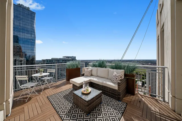 a view of a balcony with wooden floor and furniture