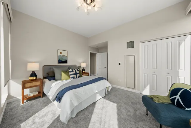 a bedroom with bed and a large window