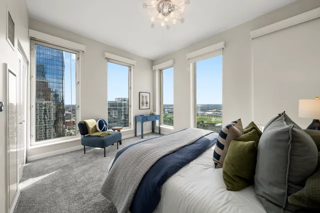a bedroom with a bed and a chandelier