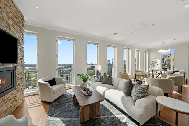 a living room with fireplace furniture and a flat screen tv