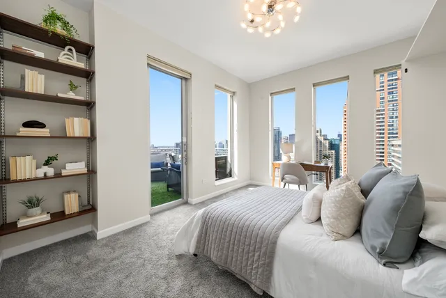 a bedroom with a bed and a chandelier