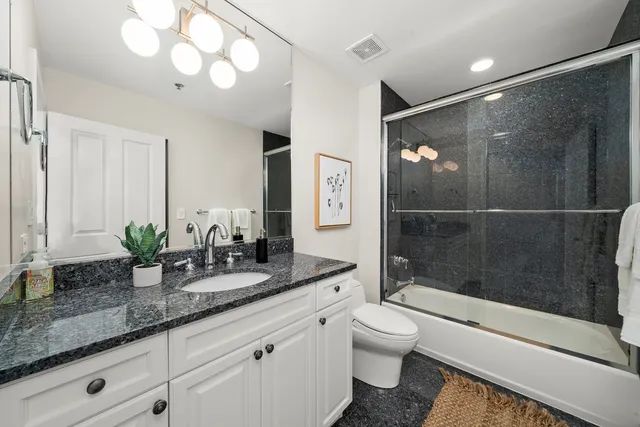 a view of a patio with couches table and chairs and potted plants