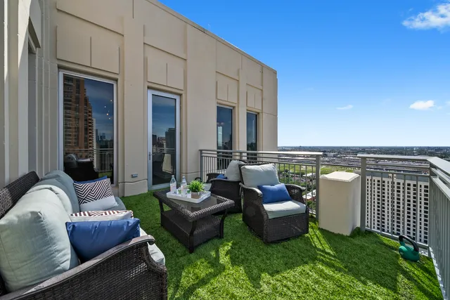 a view of a terrace with couches and pool