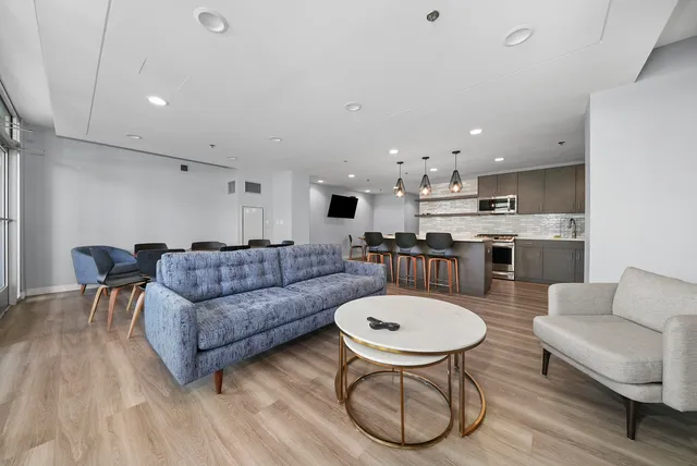 a living room with furniture and wooden floor