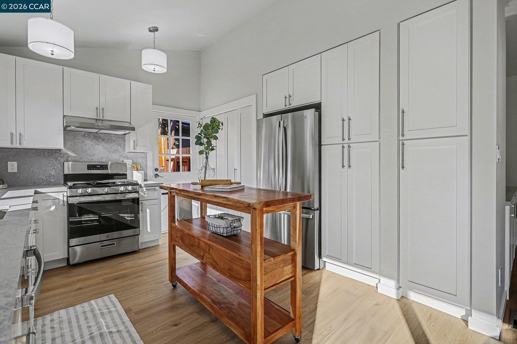 691 Rincon Road El Sobrante, CA 94803 - Photo 11 of 30 a kitchen with stainless steel appliances a stove a refrigerator and cabinets