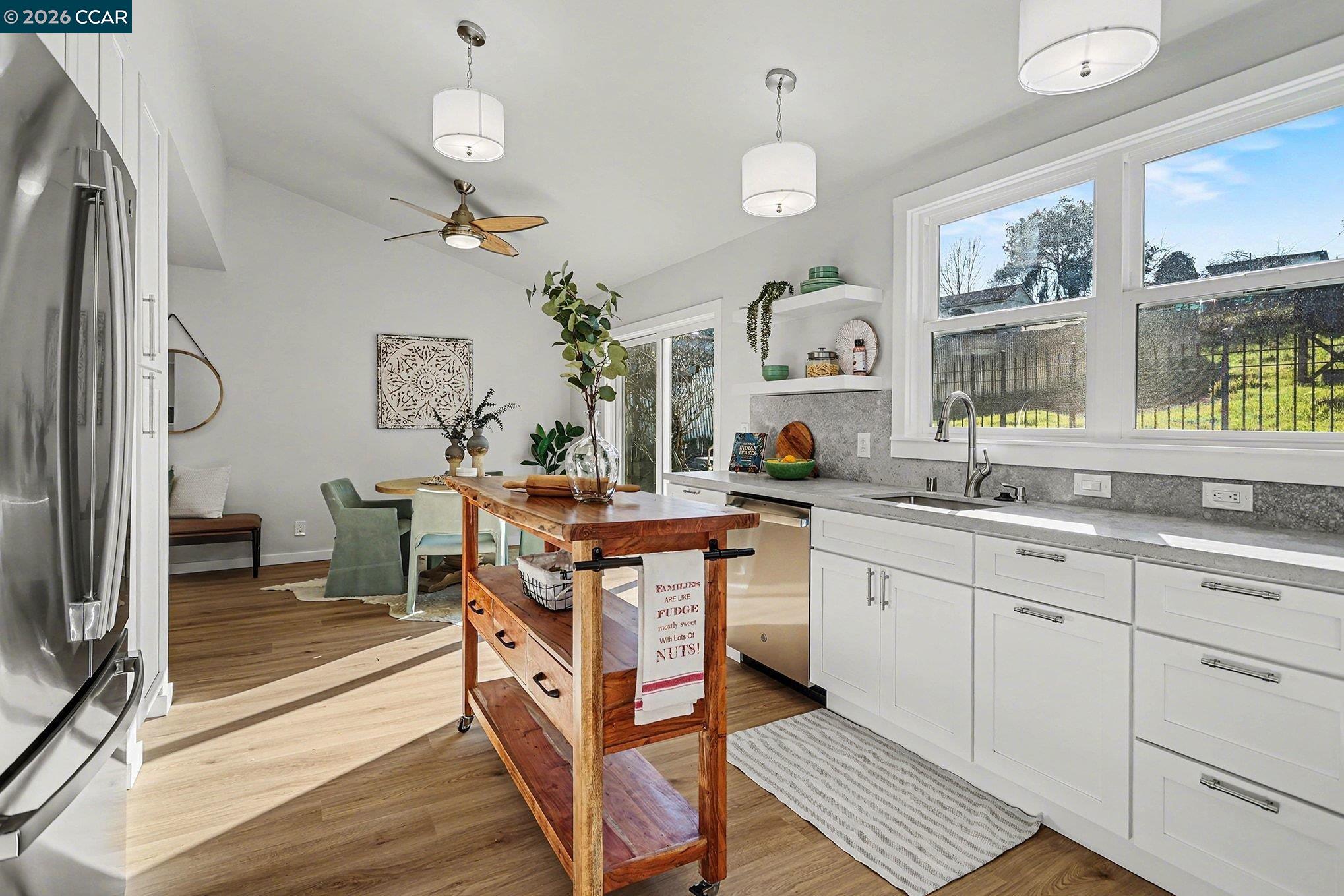 691 Rincon Road El Sobrante, CA 94803 - Photo 12 of 30 a kitchen with cabinets a sink appliances and a counter top space