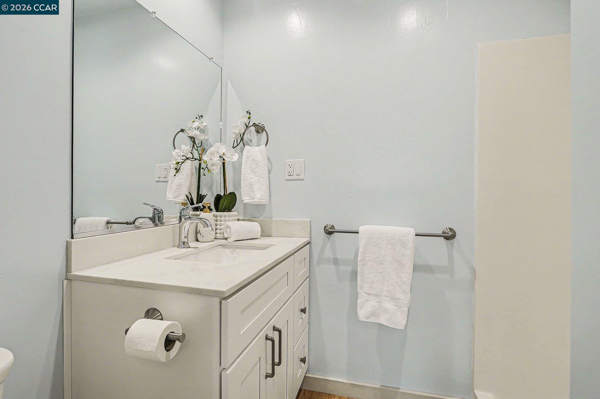 691 Rincon Road El Sobrante, CA 94803 - Photo 18 of 30 a bathroom with a sink vanity and a mirror
