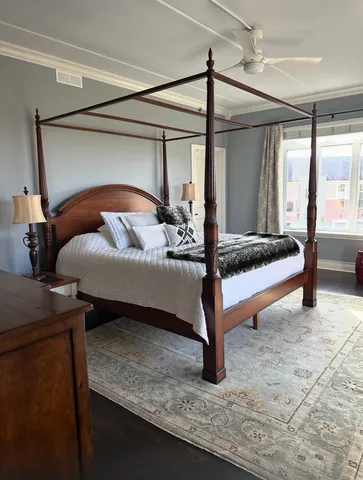 a bedroom with a bed and large mirror