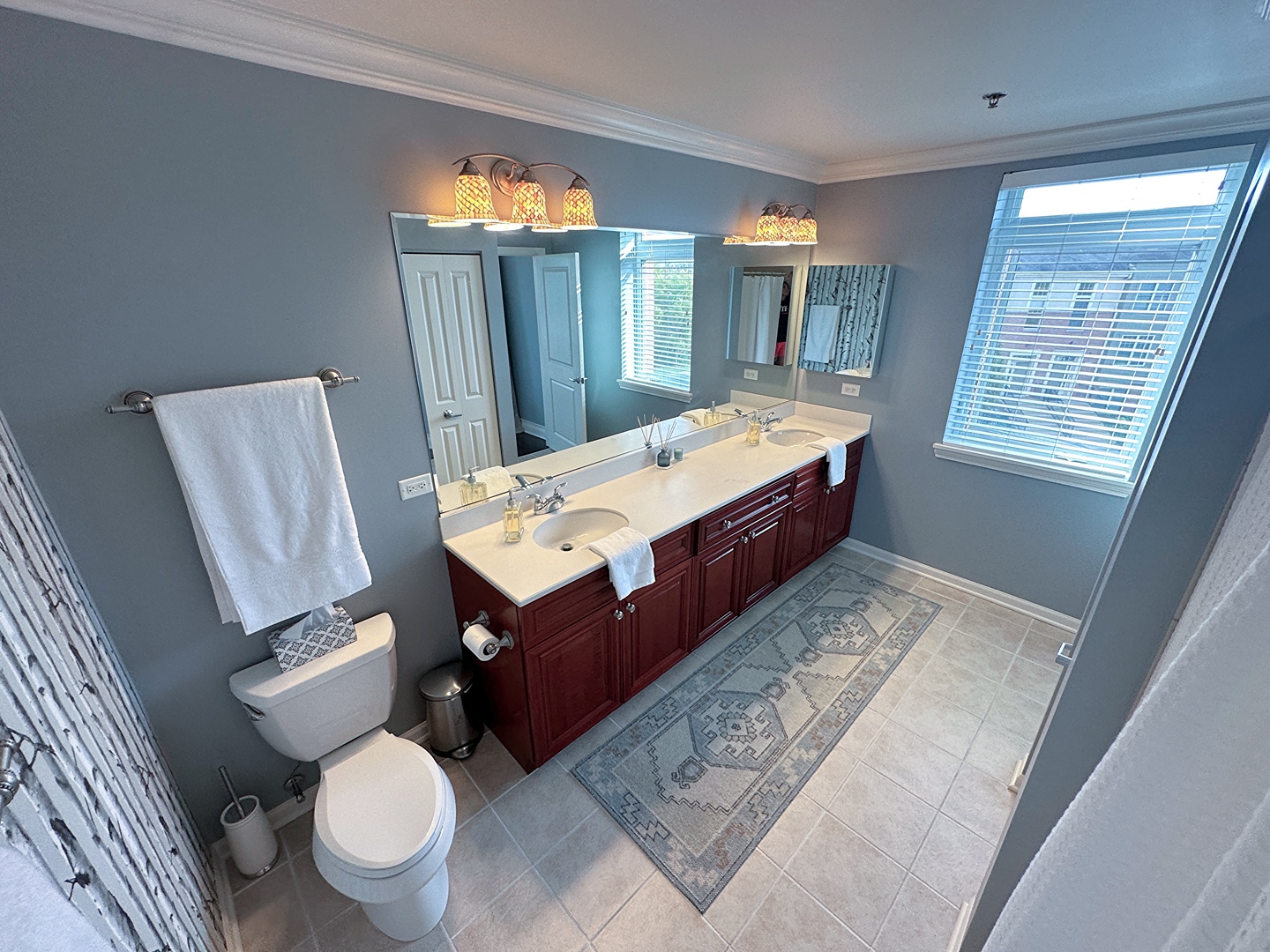 1199 East Port Clinton Road, Unit 304 Vernon Hills, IL 60061 - Photo 18 of 29 a spacious bathroom with a granite countertop toilet sink and mirror