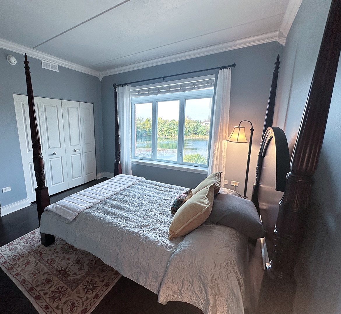 1199 East Port Clinton Road, Unit 304 Vernon Hills, IL 60061 - Photo 20 of 29 a bed sitting in a bedroom next to a window