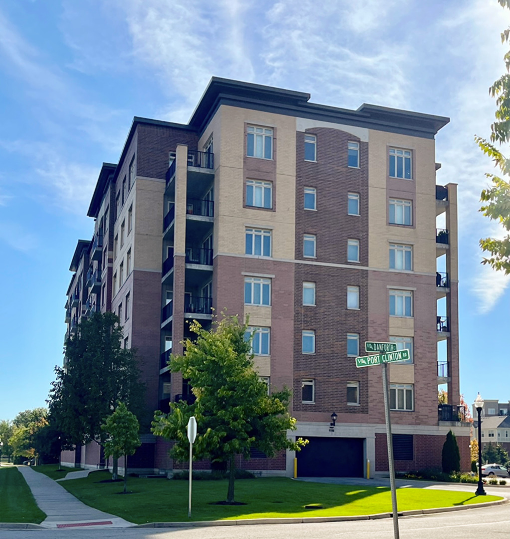 1199 East Port Clinton Road, Unit 304 Vernon Hills, IL 60061 - Photo 2 of 29 a front view of a building with garden