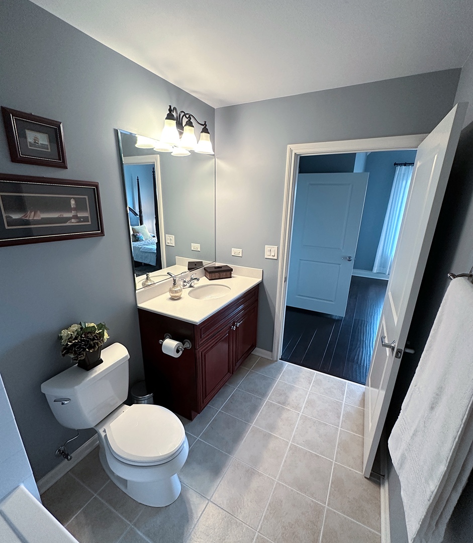 1199 East Port Clinton Road, Unit 304 Vernon Hills, IL 60061 - Photo 22 of 29 a bathroom with a sink vanity granite and toilet