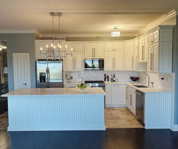 a kitchen with kitchen island granite countertop wooden cabinets a stove a sink and dishwasher