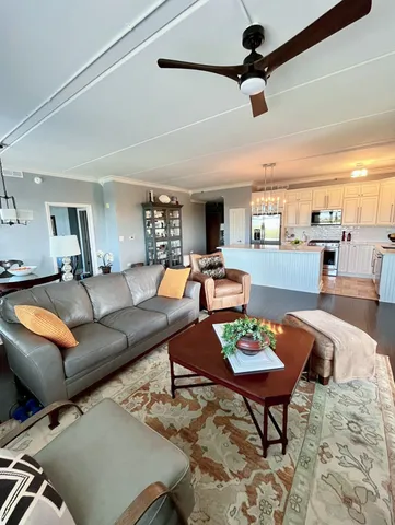 a living room with furniture and view of kitchen