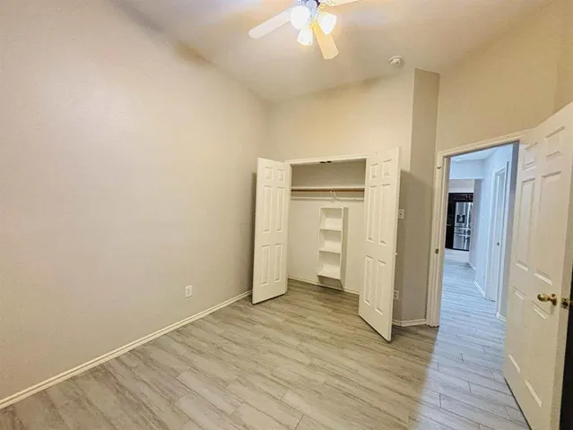 a view of an empty room and wooden floor