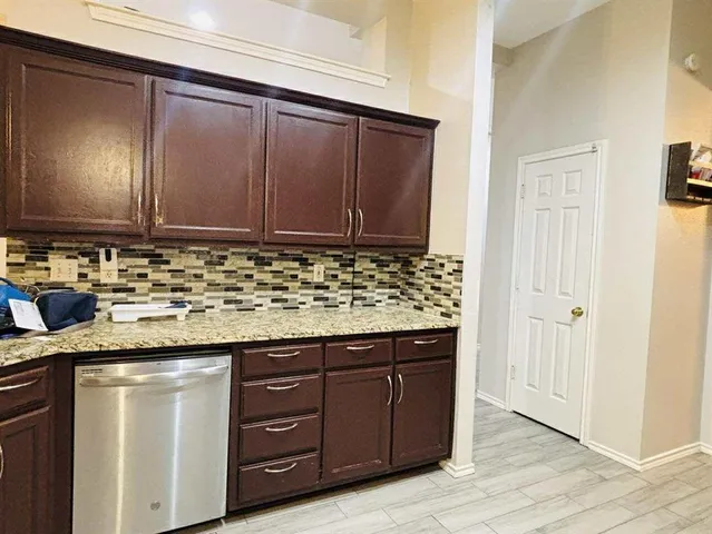 a kitchen with granite countertop cabinets and sink