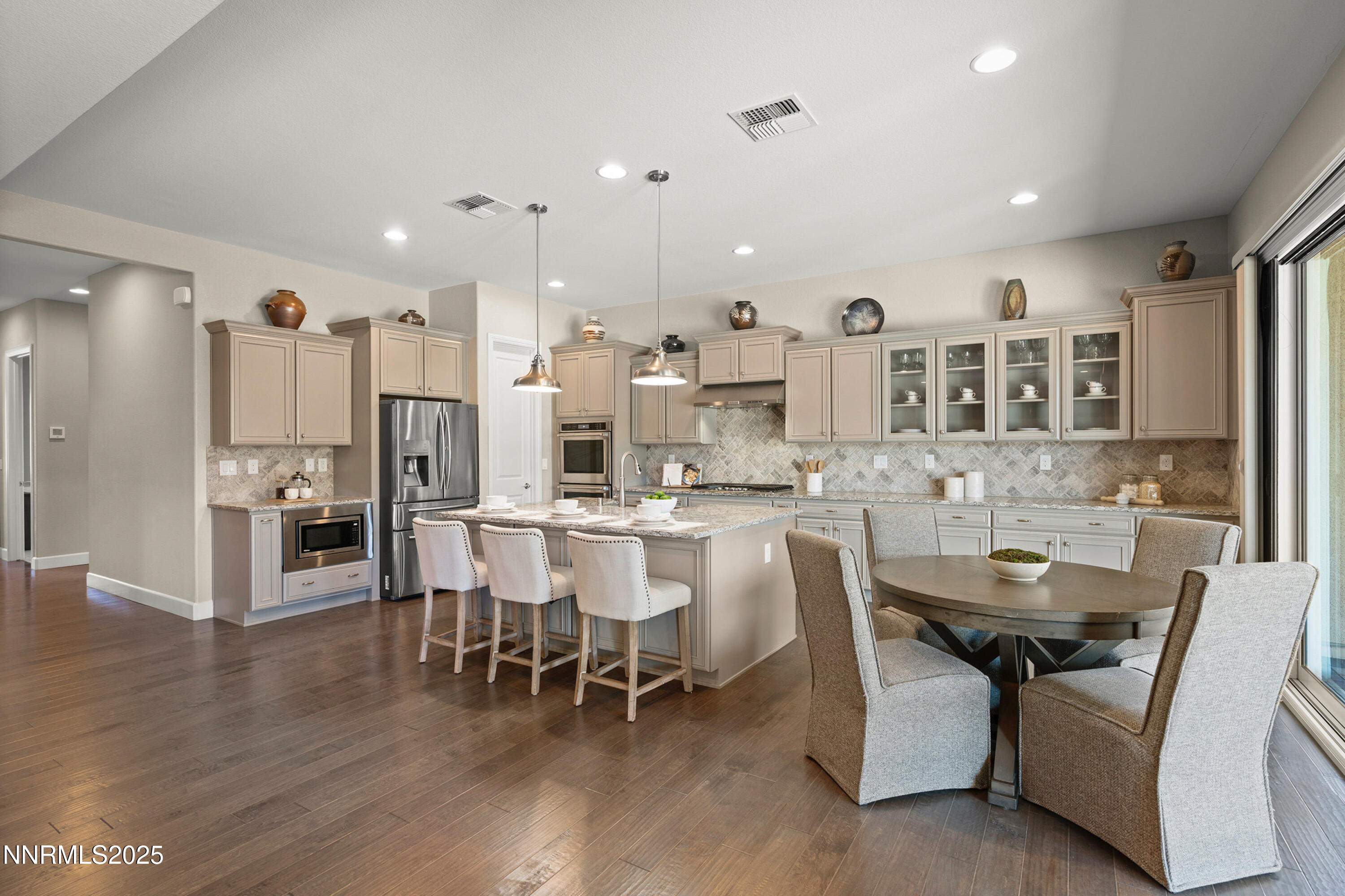 2910 Hasufel Way Reno, NV 89521 - Photo 12 of 46 a dining room with stainless steel appliances kitchen island granite countertop a dining table chairs and view kitchen