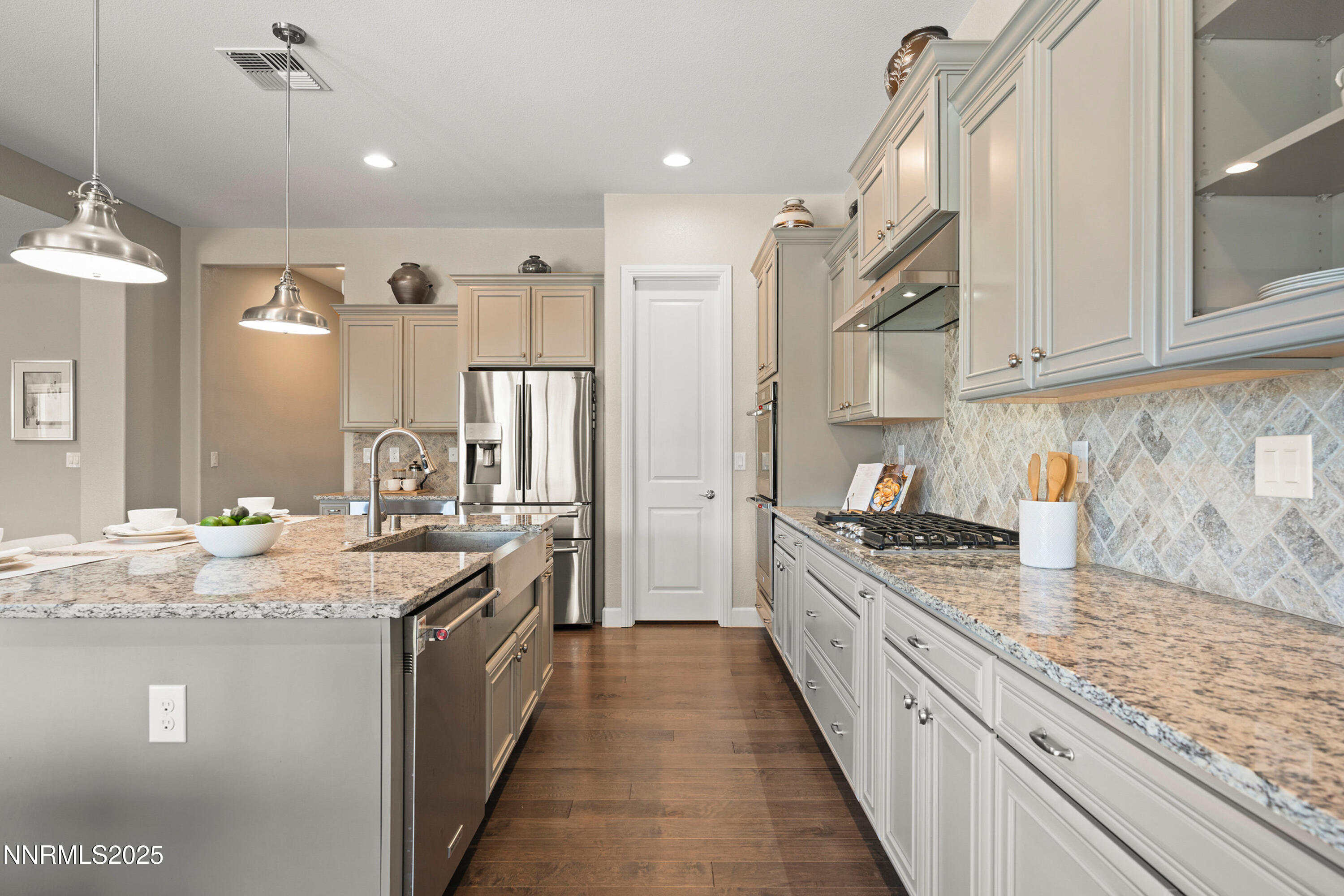 2910 Hasufel Way Reno, NV 89521 - Photo 16 of 46 a large kitchen with stainless steel appliances granite countertop a lot of counter space and wooden floor