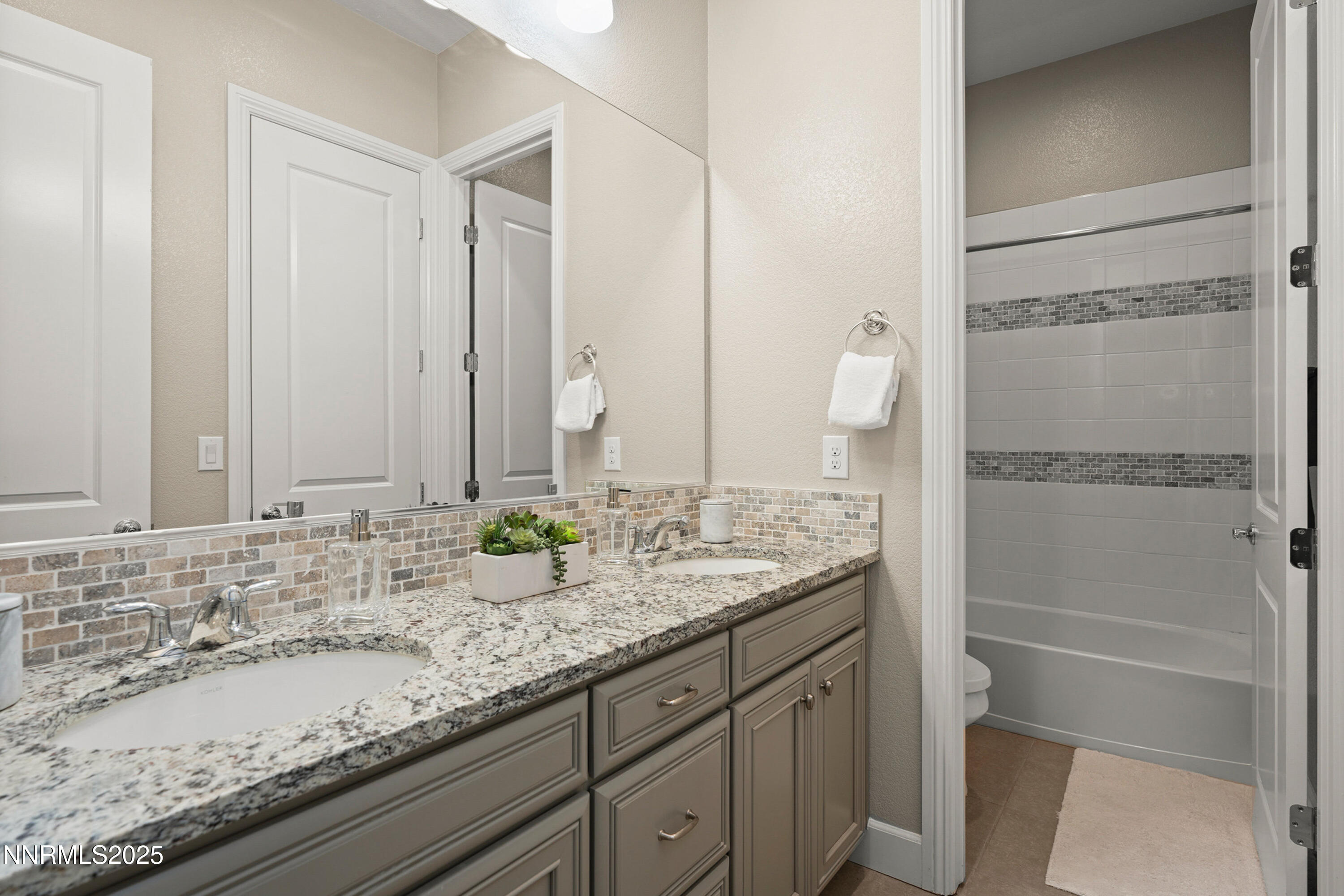 2910 Hasufel Way Reno, NV 89521 - Photo 21 of 46 a bathroom with a granite countertop sink and a mirror