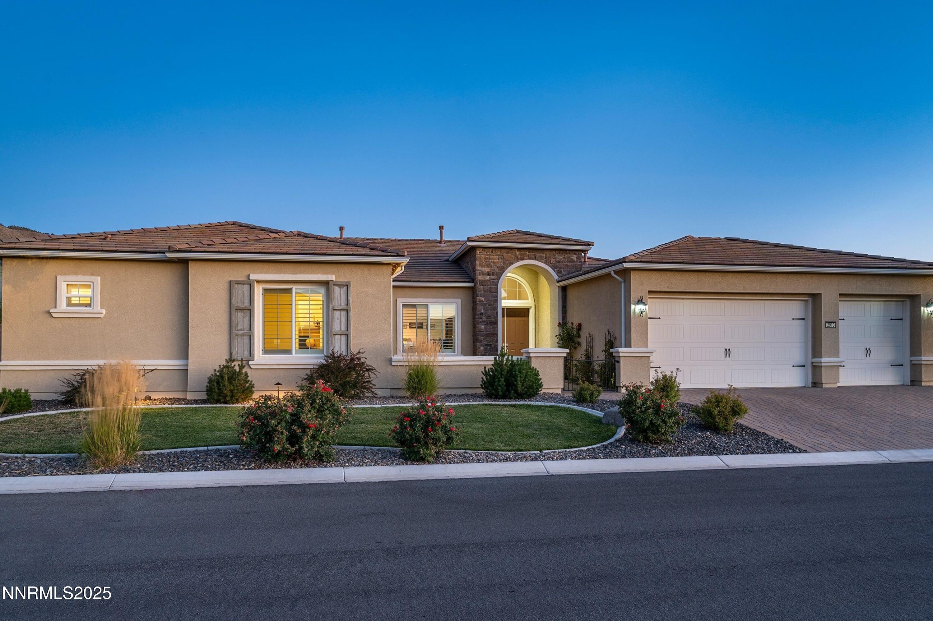 2910 Hasufel Way Reno, NV 89521 - Photo 45 of 46 a front view of a house with a yard and garage