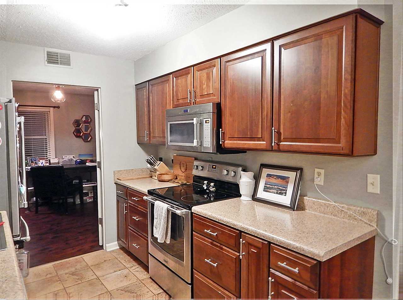 461 Dove Valley Road Collierville, TN 38017 - Photo 9 of 40 a kitchen with stainless steel appliances granite countertop a stove a sink and a microwave