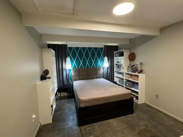 a bed room with a bed and a window