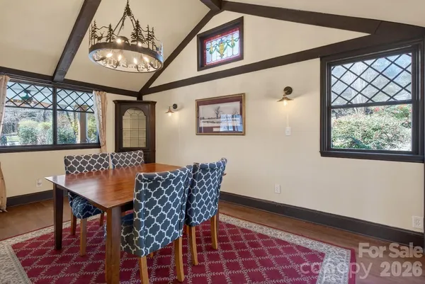 a view of a dining room with furniture wooden floor and a chandelier