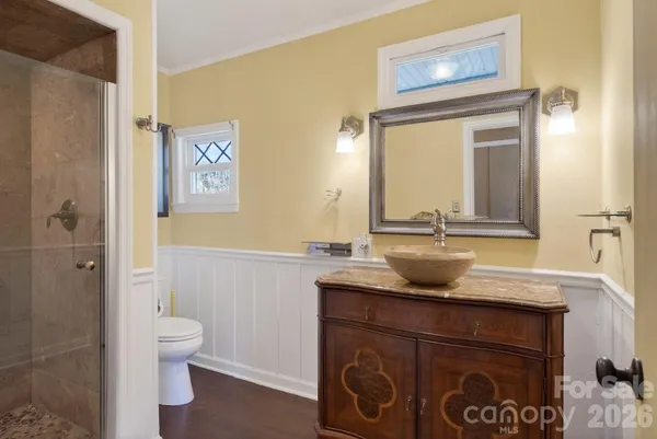 a bathroom with a granite countertop sink toilet and shower