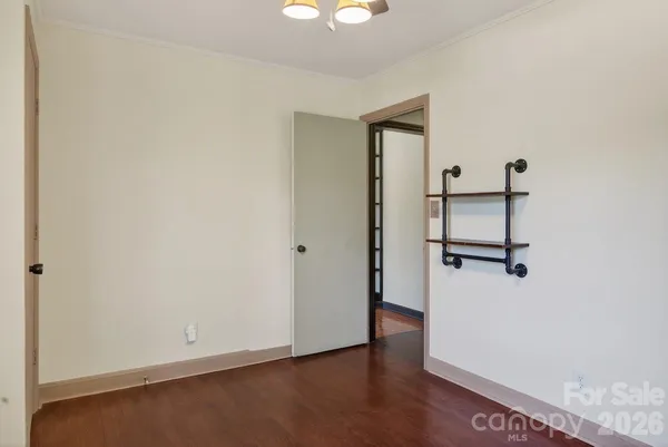a view of a hallway with wooden floor and entryway