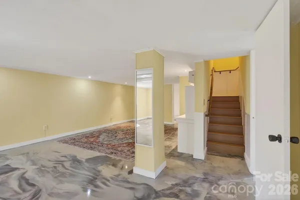 a view of a livingroom with a dinning table and chandelier