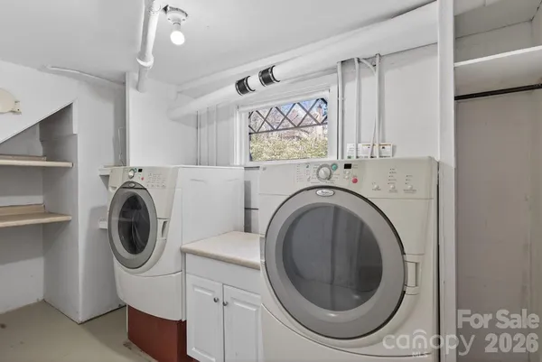 a view of a livingroom with a furniture a flat screen tv and staircase