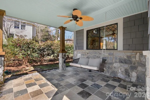 a living room with a couch and a chandelier