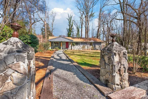 a view of a house with a yard and sitting area