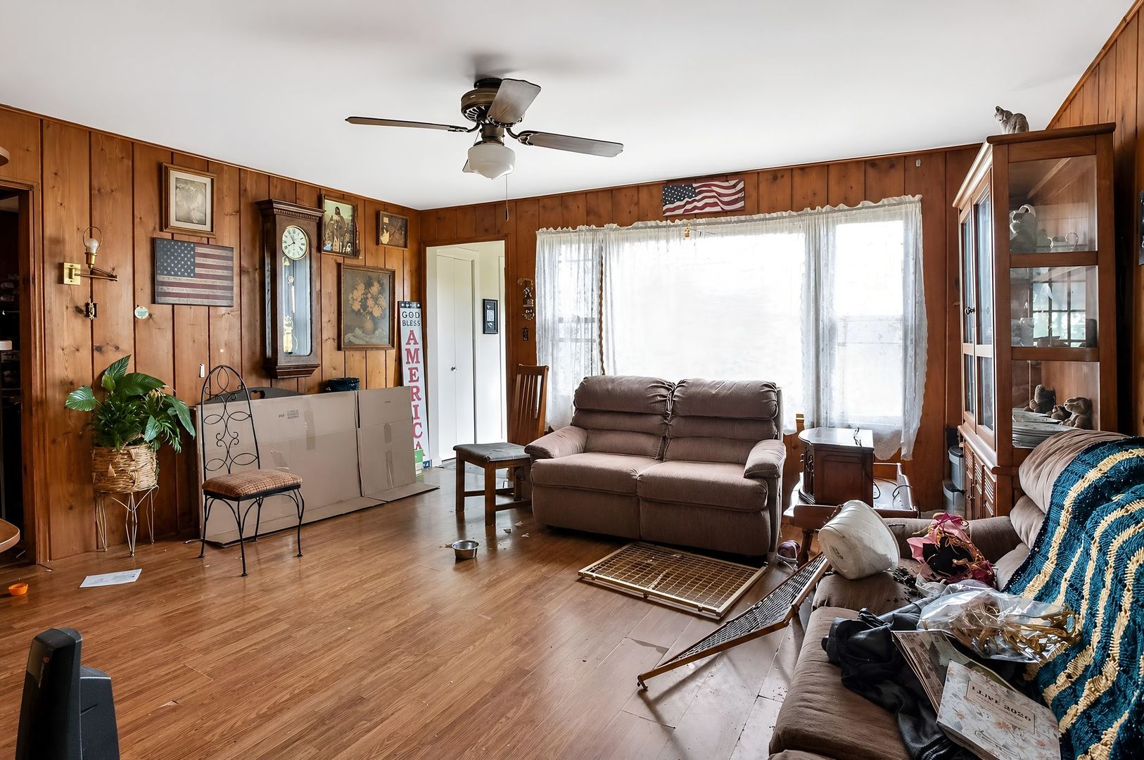 1622 Chicago Street Dixon, IL 61021 - Photo 11 of 31 a living room with furniture ceiling fan and a window