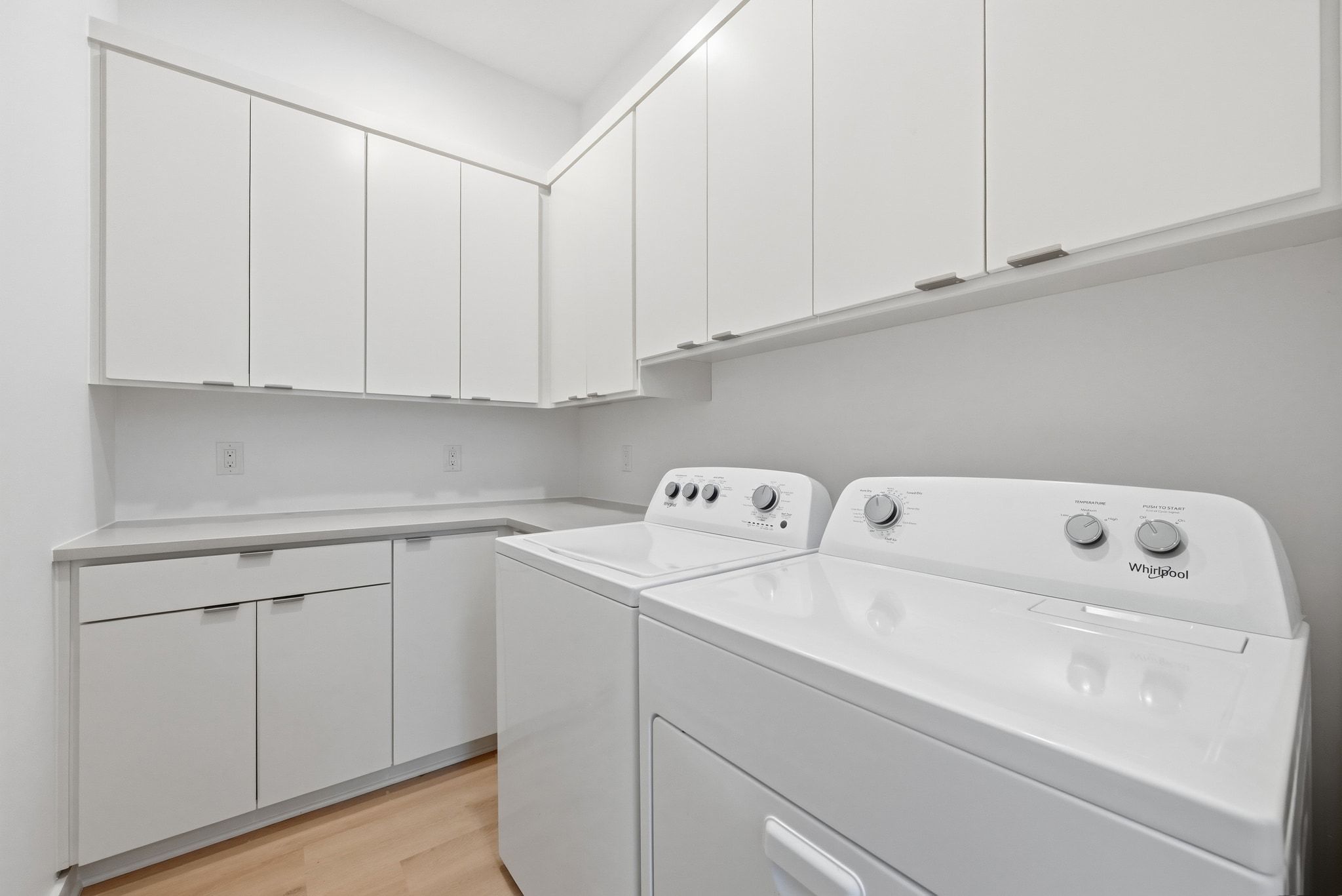 2811 Garwood Street, Unit B Austin, TX 78702 - Photo 16 of 24 Laundry area with light wood-type flooring, independent washer and dryer, and cabinet space