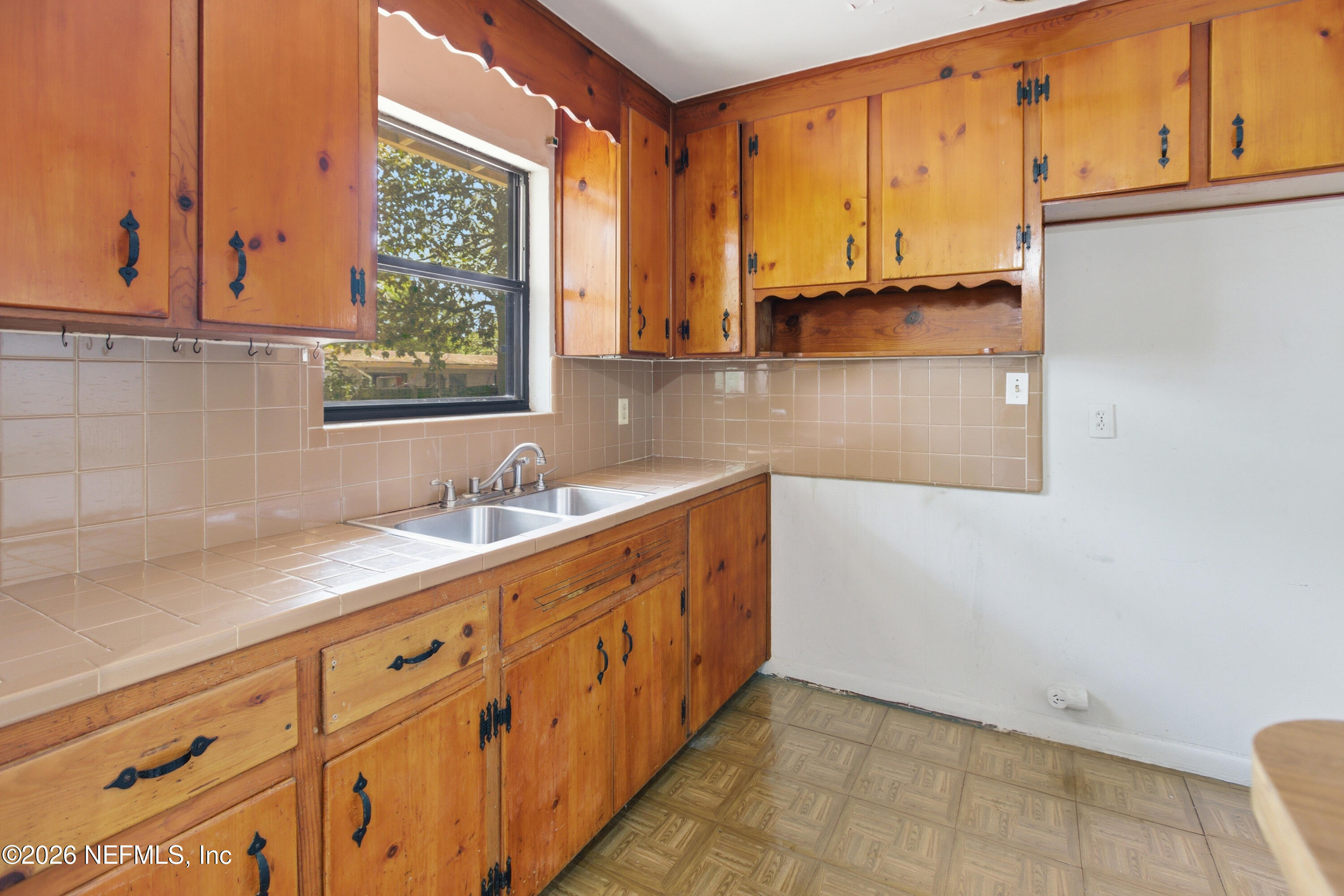 6818 Merrill Road Jacksonville, FL 32211 - Photo 19 of 21 a bathroom with a sink and a window