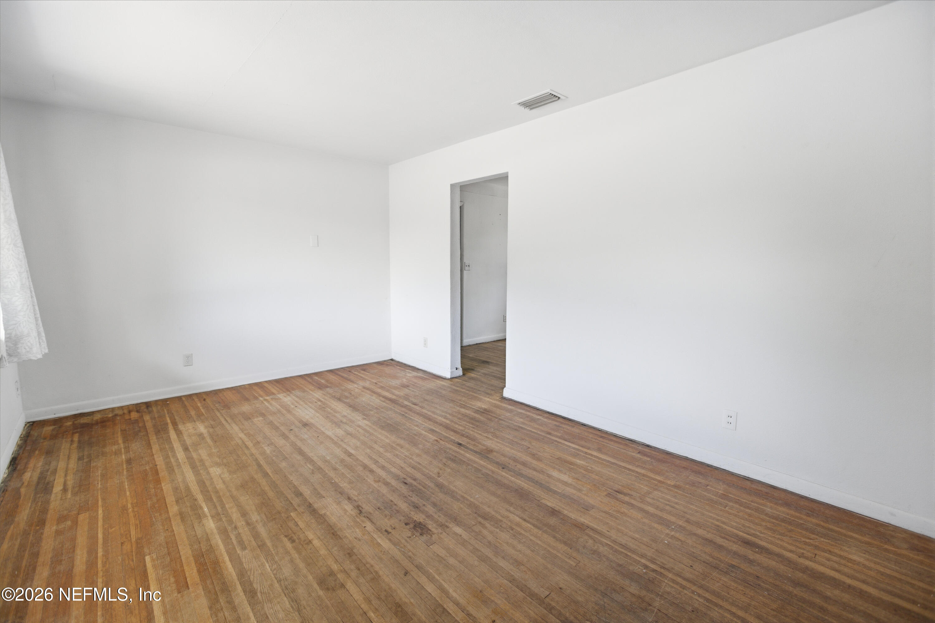 6818 Merrill Road Jacksonville, FL 32211 - Photo 4 of 21 a view of an empty room with wooden floor