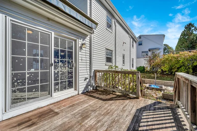 a view of balcony with wooden floor and fence