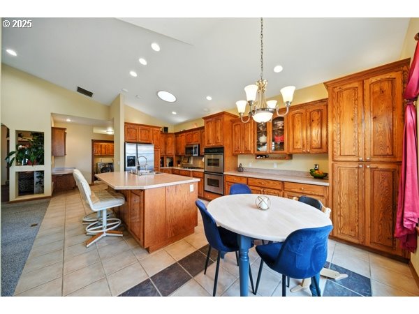 84634 Winesap Road Milton Freewater, OR 97862 - Photo 12 of 46 a dining room filled chandelier and wooden furniture