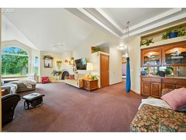 a spacious bedroom with furniture and a wooden floor