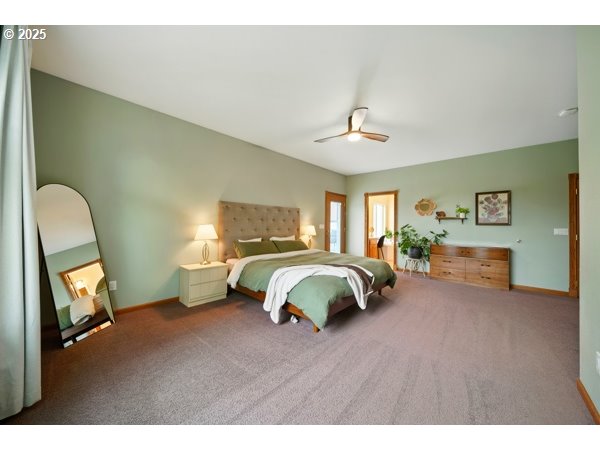 84634 Winesap Road Milton Freewater, OR 97862 - Photo 23 of 46 a spacious bedroom with a bed a dresser and painting on the wall